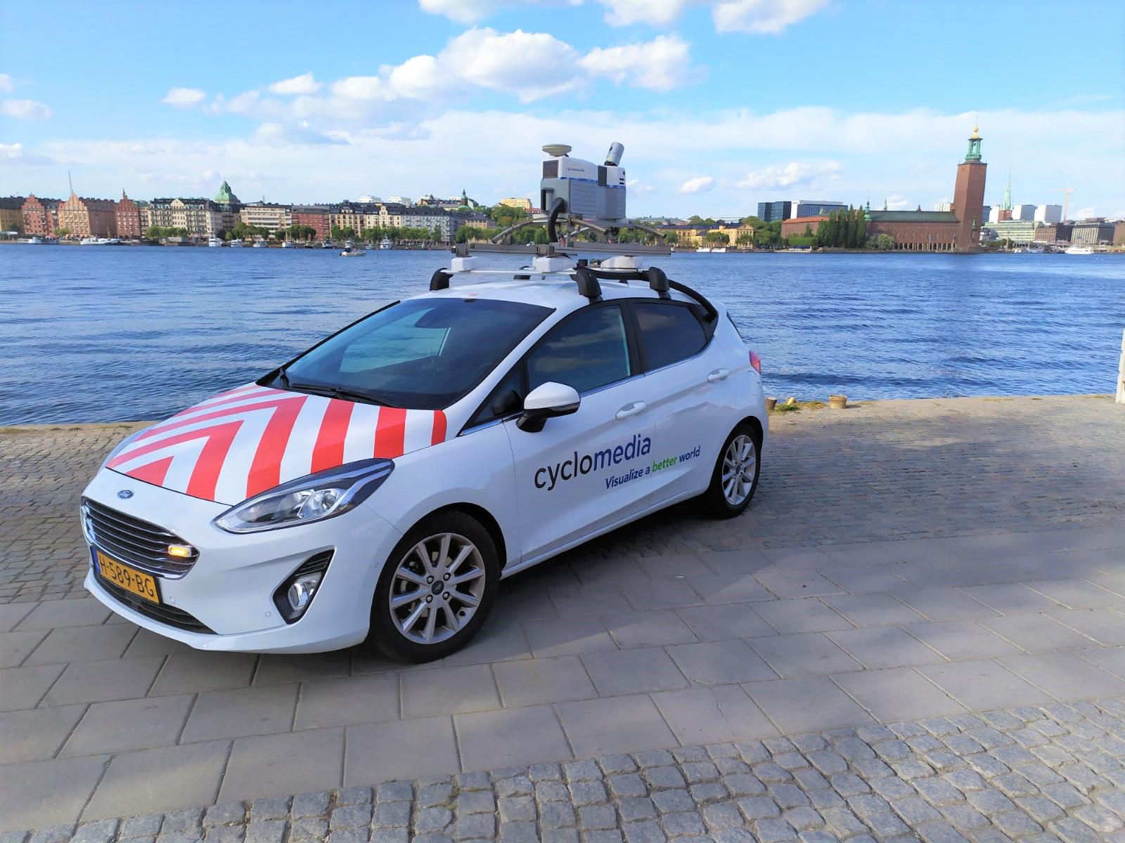 Ein Auto mit rot-weißem Muster und einer Kamera auf dem Dach.